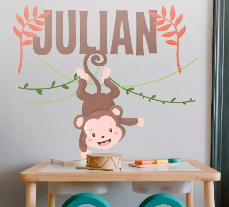 Vinilo pared Lindo bebé mono colgando de la rama - TenVinilo